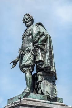 Antwerpen, Belgium - June 23, 2019: Closeup of bronze Peter Paul Rubens statue against light blue sky on Groenplaats.