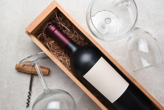 Cabernet Wine Still Life: A bottle in wood case with glasses and corkscrew.