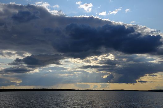 The picture shows rainstrom and thunderstorm clouds over lake