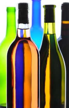 Wine Bottles backlight with shallow depth of field in an abstract arrangement. Vertical composition.