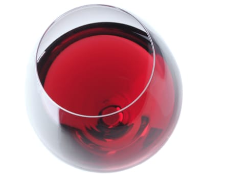 Red Wine Glass Viewed from high angle over light gray background with slight reflection 