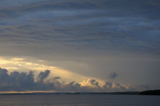 The picture shows rainstrom and thunderstorm clouds over lake