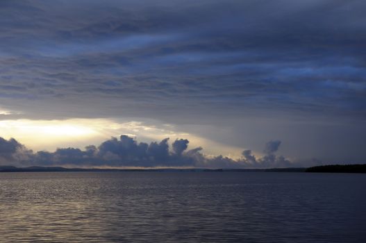 The picture shows rainstrom and thunderstorm clouds over lake