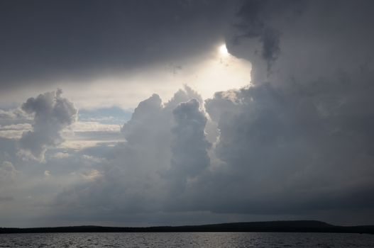 The picture shows rainstrom and thunderstorm clouds over lake