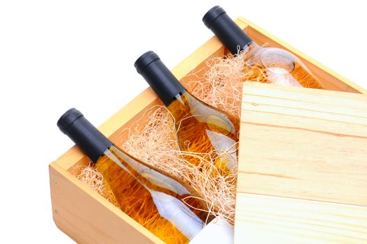 Closeup of three white wine bottles on their side in a wooden crate. Crate lid is pulled partially back exposing the bottles and packing excelsior. Horizontal format isolated on white.