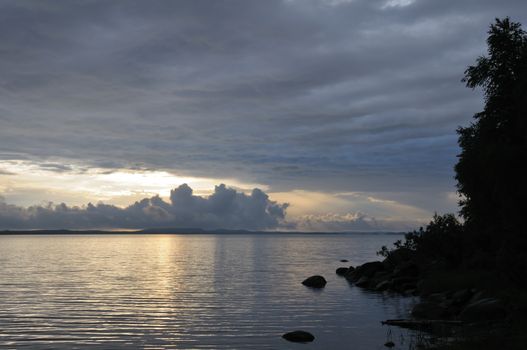 The picture shows rainstrom and thunderstorm clouds over lake