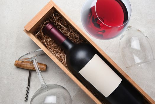 Cabernet Wine Still Life: A bottle in wood case with glasses and corkscrew.