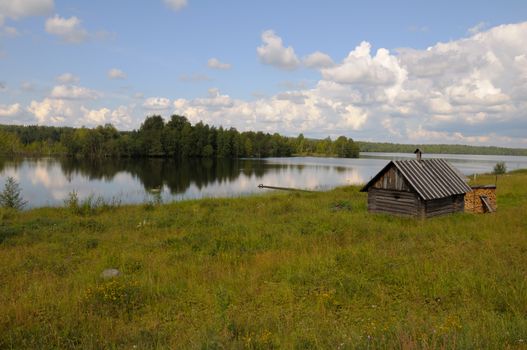 A small bathhouse on a beautiful lake in a forest