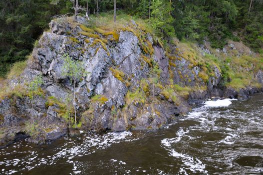 This picture shows ancient rocks near the Kivach - the most powerfull waterfall in Karelia region (approximately 12 meters)