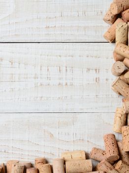 A partial cork frame on two sides of the image. High angle shot on a rustic whitewashed wood table, Suitable for wine lists with lots of copy space.