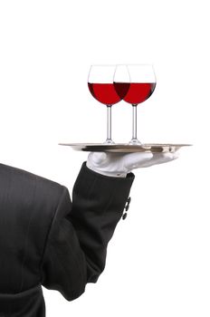 Butler in Tuxedo seen from behind with two red Wine Glasses on Tray held at shoulder height vertical format over white