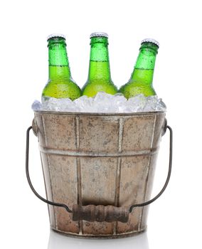 Closeup of an old fashioned beer bucket with three green bottles of cold beer. Isolated on white with reflection.