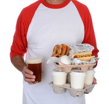 Closeup of a baseball fan carry trays of food and souvenirs back to his seat. The man is unrecognizable and isolated on white.