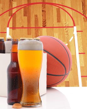 A Basketball Six Pack of Beer Bottles and a Glass of Ale on a white table top with Court in background. Great for NBA of March Madness themed projects.
