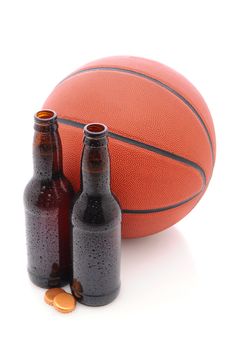 Two Beer Bottles with their caps off in front of a basketball, isolated on white, with slight reflection.