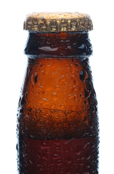 Closeup of a brown beer bottle neck and cap covered with condensation. Vertical format over a white background. 