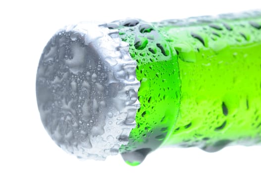 Closeup of a brown beer bottle cap and neck covered with condensation. Horizontal format over a white background. Bottle is at an angle focus on the bottle cap. Shallow Depth of Field.
