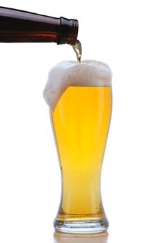 Glass of Beer being Poured from Bottle with Foam Drip and Reflection isolated on white