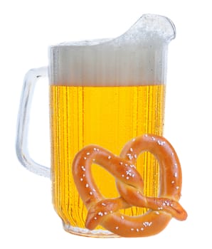 Pitcher of beer in vertical format over white, with a large soft pretzel leaning against.