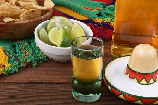 Tequila shot with limes, salt, chips and Mexican blanket. Great for Cinco de Mayo themed projects or Mexican restaurants.