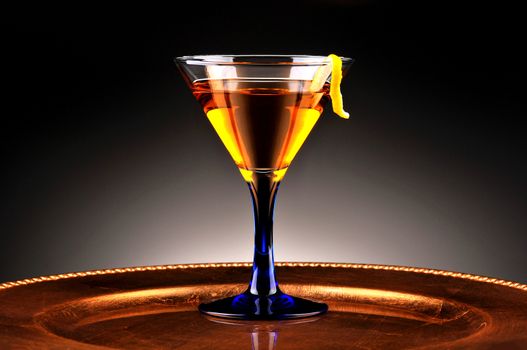 Whiskey Drink and Lemon Twist with light to dark spot lit background. Horizontal Composition
