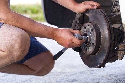 Old and dirty rear dump break of the vehicle for repair. Brakes on a car with removed wheel. Detail image of cars break assembly before repair