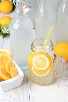 Old fashioned sparkling lemonade shot from a high angle. Vertical format on a rustic wooden farmhouse style table.