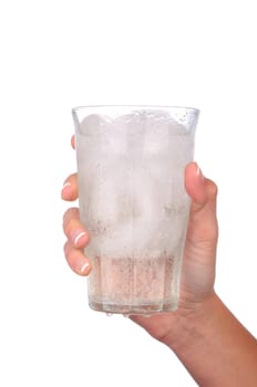  Closeup of a woman's hand holding a cold glass of water and ice over a white background