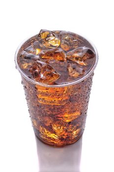 Clear Plastic Cup of Cola with Ice isolated on white with reflection vertical format high angle