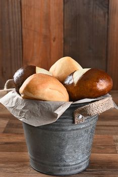 Closeup of a bucket filled with dinner rolls. Vertical format with copy space.