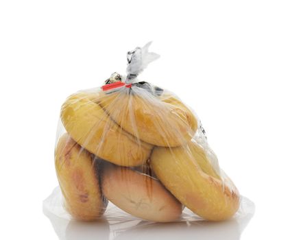 Closeup of a plastic bag full of bagels sealed with a twist tie.