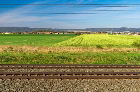 Railroad tracks in the beautiful green landscape.