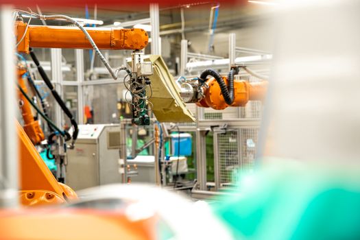 use of robotic arms in the production of cars in the automotive industry.