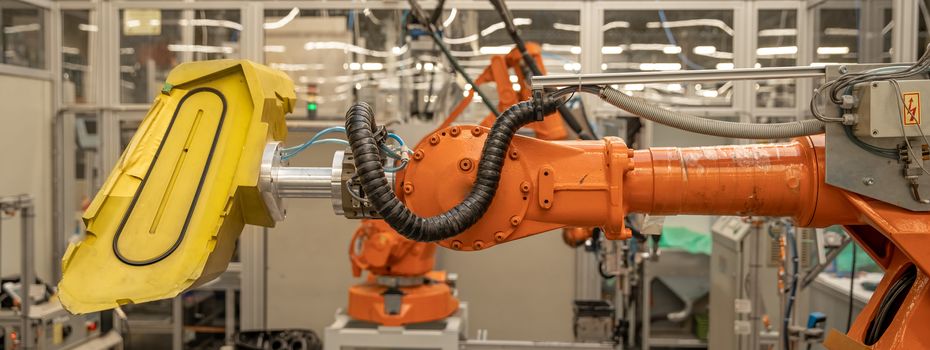 robot arms in the factory performs precise work according to the specified program.