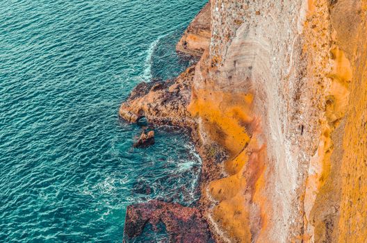 Aerial view of sea waves and rocks in Napoli, Italy