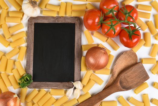 Top view of a blank chalkboard with the ingredients for an Italian meal. Horizontal format.