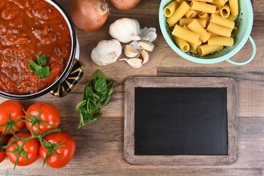 Top view of ingredients for an Italian Meal. Horizontal format with a blank chalkboard.
