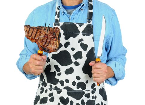 Closeup of a man holding a fork with a barbecued t-bone steak. Man is unrecognizable isolated on a white background.