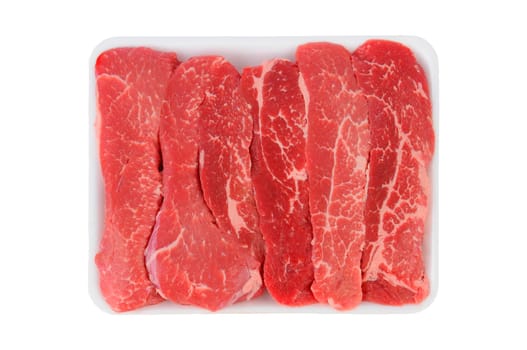 Tri-Tip Steak Strips on a foam meat tray. Horizontal format over white.