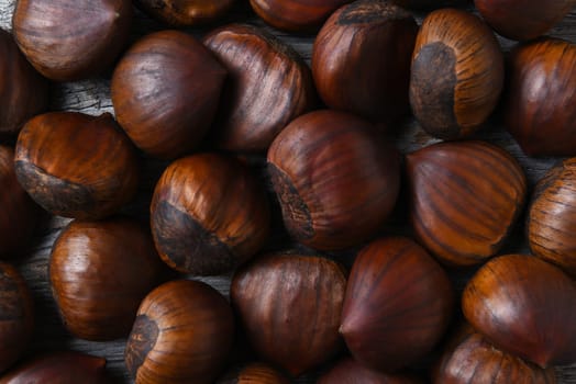 Top view closeup of a group of Chestnuts on a rustic wood table.