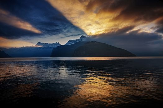 dramatic reflection in the sky and clouds during sunset at lake Lucerne in Switzerland