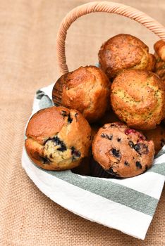 Basket of fresh baked muffins. Blueberry, Cranberry, Lemon Poppy Seed are among the varieties shown.