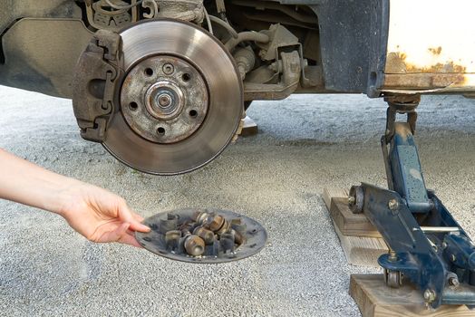 Old and dirty rear dump break of the vehicle for repair. Brakes on a car with removed wheel. Detail image of cars break assembly before repair