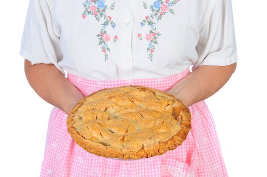 Closeup of a woman holding a freshly baked apple pie in fron of her torso. Woman is unrecognizable.