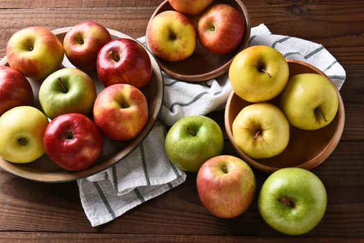 High angle still life of a group of fresh picked varieties of apples, Fuji, Golden Delicious, Braeburn, Granny Smith, and Gala. 