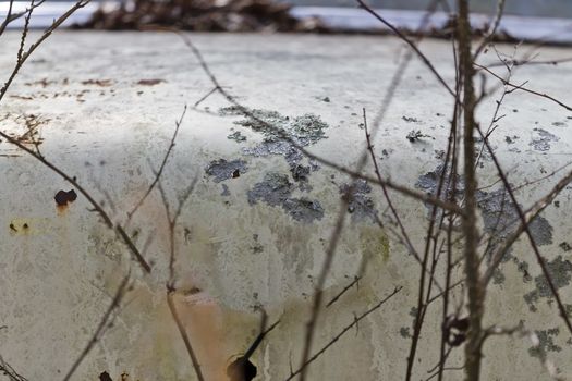 An old abandoned car sits in a field as it rusts away
