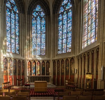 Kortrijk, Flanders, Belgium - September 17, 2018: Chancel of historic chapel in Notre Dame Church honoring all Dukes of Flanders through the ages. Stained glass windows and series of paintings.