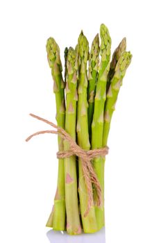 A bunch of fresh asparagus spears tied with twine isolated on a white background. Vertical format with slight reflection.