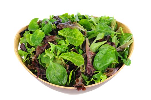 A Wooden bowl full of assorted salad greens, including, spinach, arugula, and romaine. Horizontal format on a white background.