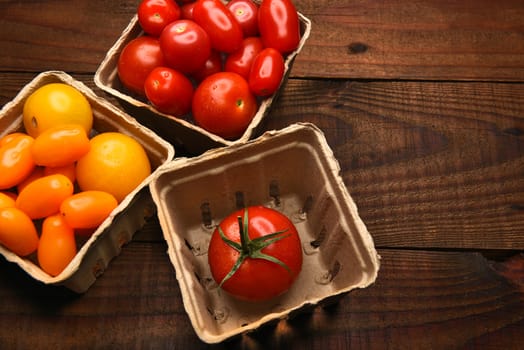 Top view of produce baskets filled with a variety of medley tomatoes. Horizontal format with copy space.